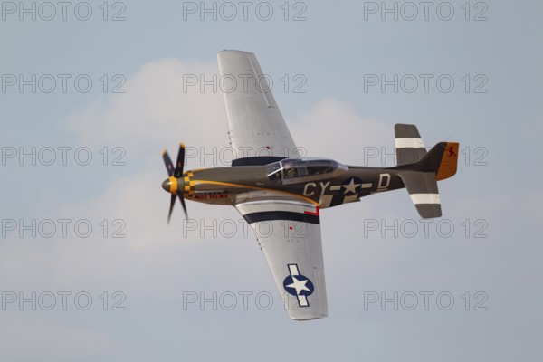 North American Aviation P-51 Mustang warbird military aircraft in United States of America USAF colours flying, England, United Kingdom