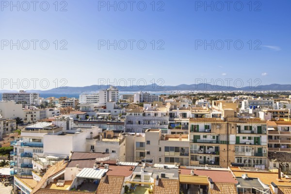 Skyline view over a residential area with apartment houses and the mountains and the Mediterranean Sea in the background a sunny summer day, Can Pastilla, Mallorca, Spain