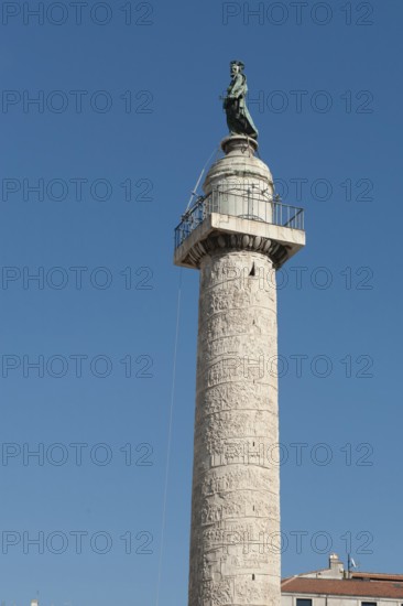 Above statue of Saint Peter Statue of Saint Peter the Apostle on 40 metre high Trajan's Column Victory Column Column of honour for Roman Emperor Trajan, below statue small platform circulation with railing, Trajan's Forum, Rome, Lazio, Italy