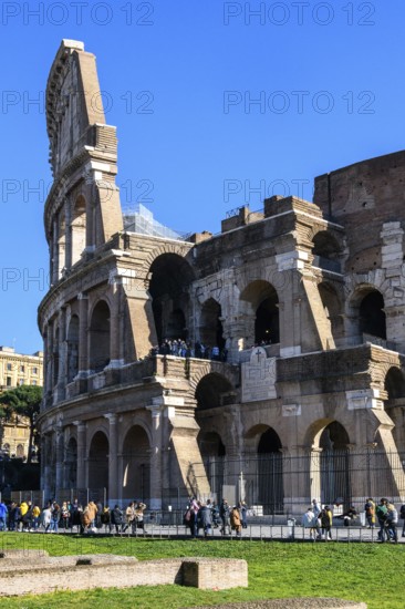 View of partially restored façade on the left Exterior façade with large arched windows Brick arches of ancient Roman Colosseum, centre right Exposed inner masonry with two floors with former surrounding corridors, Rome, Lazio, Italy