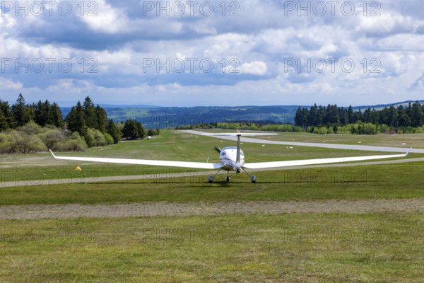 Motorised glider taxiing to the runway at Wasserkuppe airfield, Rhön, Gersfeld, Fulda district, Hesse, Germany