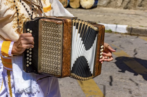 Accordionist with his instrument at the Congado festival in Minas Gerais, Belo Horizonte, Minas Gerais, Brazil