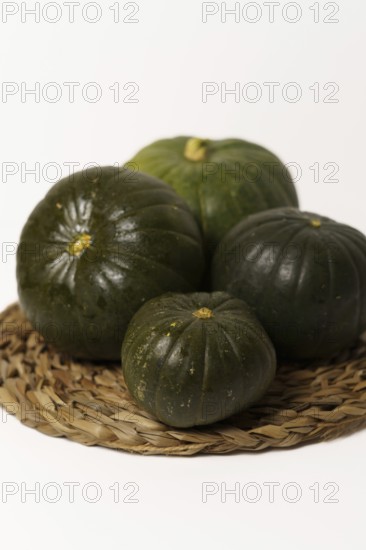 Green pumpkins cut in half on wood and white background