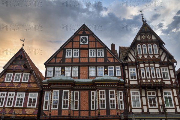 Characteristic half-timbered houses in the historic old town, Brick Gothic, splendidly decorated wooden beams, pier railway, evening sky, Celle, Lüneburg Heath, Germany