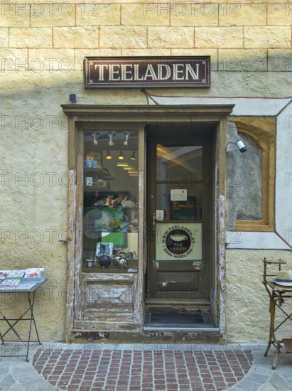 Entrance to a small, cosy tea shop in an old town with decorative shop window Mödling Lower Austria Austria