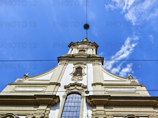 Baroque church façade rises majestically into the blue sky with delicate clouds Herz Jesu Kirche Graz Styria Austria