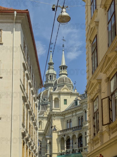 View through alley to historic towers in the old town centre of Graz Landhaus Graz Styria Austria