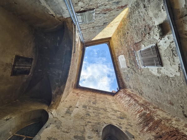 View through an open roof of blue sky with clouds surrounded by old stone walls Riegersburgs Styria Austria