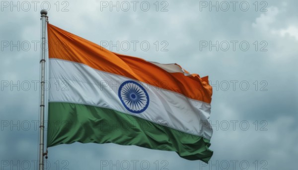 The Indian flag waves proudly against a cloudy sky, symbolizing the nation's independence and cultural heritage. The tricolor is fully displayed, AI generated