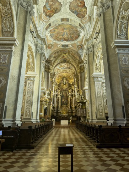 Magnificently decorated baroque interior with altar and ceiling frescoes, atmospheric play of light, Klosterneuburg Lower Austria Austria