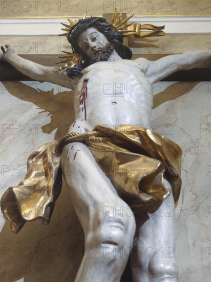 Dramatic depiction of Jesus Christ on the cross with golden elements in baroque style, Klosterneuburg Lower Austria Austria