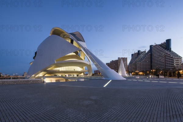 Futuristically designed building in urban surroundings with evening lighting Opera