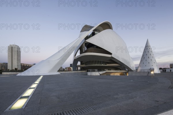 Futuristic white building with a long entrance on an empty urban space at dusk Opera