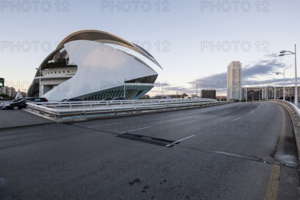 Futuristic building next to a street under a cloudy sky Opera