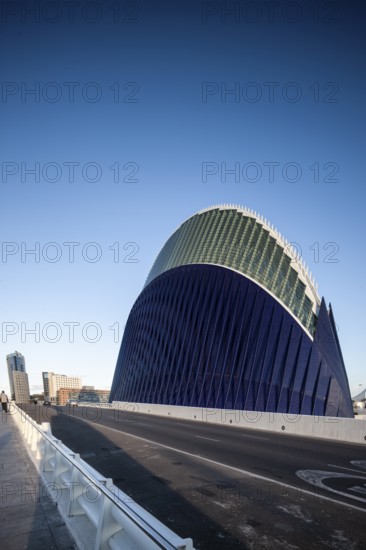 Futuristic blue building in Valencia next to a street under a clear sky