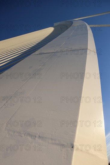 Detailed view of a structural component of a bridge under a blue sky