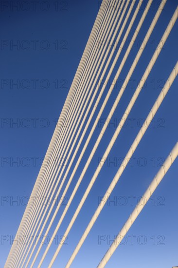Close-up of cables of a bridge against a clear blue sky