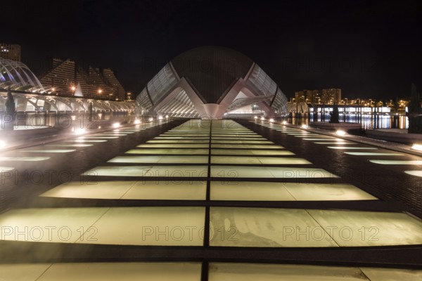 Illuminated modern architecture at night in Valencia with symmetrical design