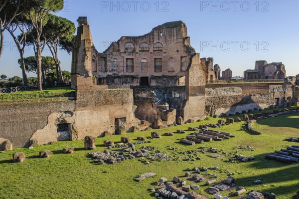 Historic Palatine Stadium Hippodrome of Roman Emperor Domitian with in the foreground by archaeologists draped lying fragments of ancient columns, with ruins of imperial lodge on Palatine Hill, Palatine Hill, Rome, Lazio, Italy