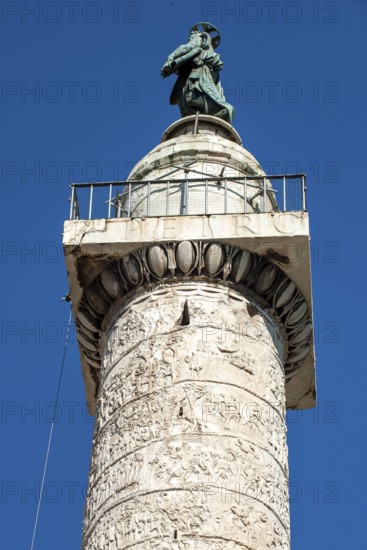 View from bottom to top of statue of Apostle Peter, Saint Peter, Saint Peter, erected in 1587 at the behest of Pope Sixtus V, below platform with railing and parts of spiral marble relief on column of honour Victory Column Trajan's Column from 113 Lunensian marble Carrara marble from for Roman Emperor Trajan from antiquity in Trajan's Forum in ancient Rome, Rome, Lazio, Italy