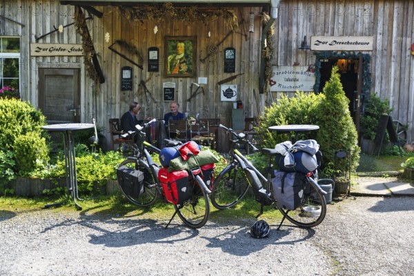 Two e-bikes, visitors in front of a country inn, Rischenau, Lügde, Weserbergland, North Rhine-Westphalia, Germany
