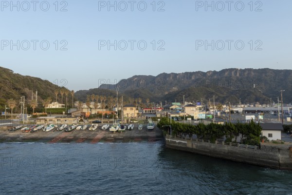 Boats in the evening light and mountain landscape in the harbour of Hamakanaya, Futtsu, Chiba Prefecture, Japan