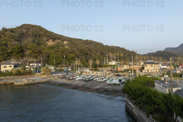 Boats in the evening light and mountain landscape in the harbour of Hamakanaya, Futtsu, Chiba Prefecture, Japan