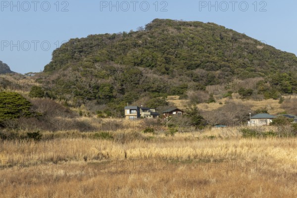 Residential houses in a rural mountain landscape in the evening light, Hota, Kyonan, Chiba Prefecture, Japan