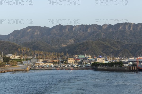 Boats in the evening light and mountain landscape in the harbour of Hamakanaya, Futtsu, Chiba Prefecture, Japan