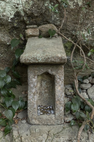 Small stone house for offerings with yen coins on the Shariki-michi Trail to Mount Nokogiri, Mount Nokogiri, Hamakanaya, Futtsu, Chiba Prefecture, Japan