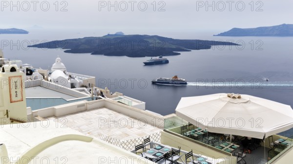View from the island's capital Fira to the uninhabited volcanic island of Nea Kameni in the caldera, cruise ship, ferry, Santorini, Cyclades, Greece