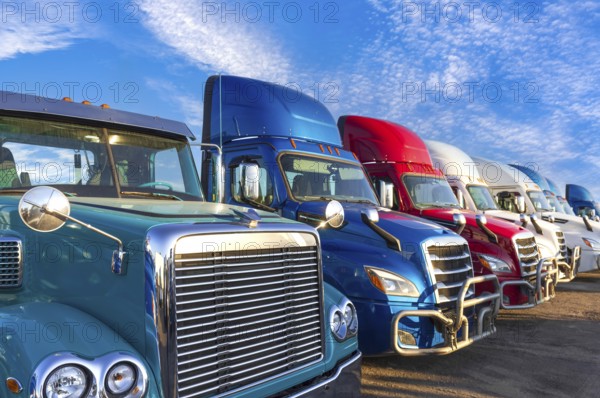 Long haul container trucks carrying commercial cargo on a parking lot ready for delivery