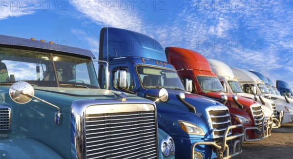 Long haul container trucks carrying commercial cargo on a parking lot ready for delivery