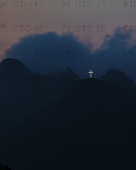Illuminated steel cross on Monte Mar di Capanna, night shot, above Porto Azzurro, Elba Island, Tuscan Archipelago National Park, Tuscany, Italy
