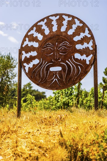 Rusty plaque with motif of the god of wine Bacchus, near the Arrighi winery, Porto Azzurro, Elba Island, Tuscan Archipelago National Park, Tuscany, Italy