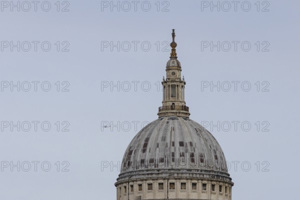 Dome of St. Pauls cathedral with a jet aircraft in the sky behind, City of London, England, United Kingdom