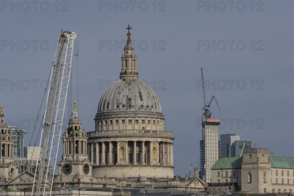 Dome of St. Pauls cathedral and mechanical cranes, City of London, England, United Kingdom