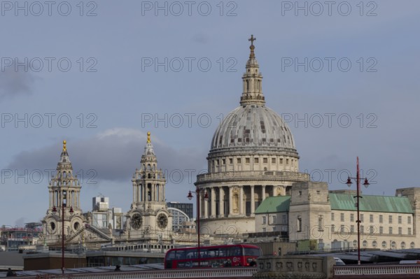 Dome of St. Pauls cathedral with a red bus driving over a bridge, City of London, England, United Kingdom