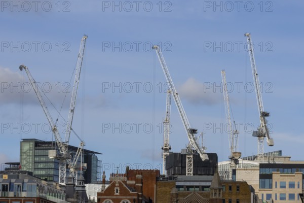 Mechanical cranes on buildings, City of London, England, United Kingdom