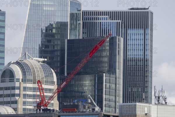 Mechanical red crane on a building, City of London, England, United Kingdom