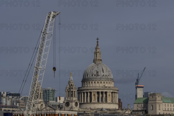 Dome of St. Pauls cathedral and mechanical cranes, City of London, England, United Kingdom