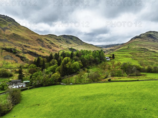 Farms and Mountains over road A591 from a drone, Grasmere Lake, Grasmere, Ambleside, Lake District, Westmorland, Cumbria, UK