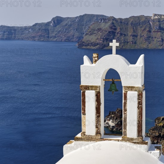 Bell tower of an orthodox church with a view of the caldera, Oia, Santorini, Cyclades, Greece