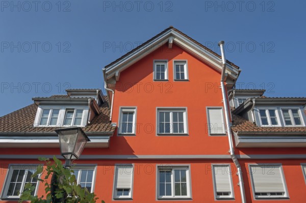 Red pointed gable facade with dormers, blue sky, Isny, Swabia, Baden-Württemberg, Germany