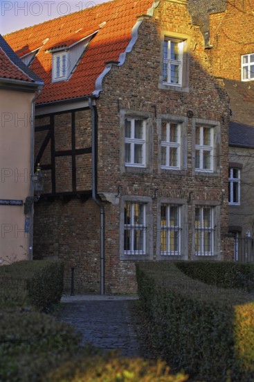 Charming half-timbered house with red tiled roof in the sunlight, Düsseldorf-Kaiserswerth