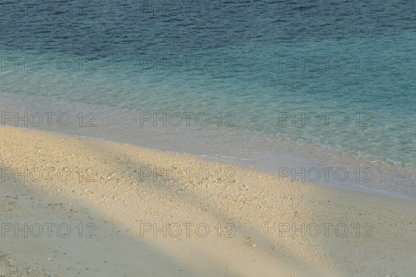 Sunlight, shade, sand and turquoise water at Sesoko-jima beach, Sesoko Island, Motobu, Kunigami District, Okinawa, Japan