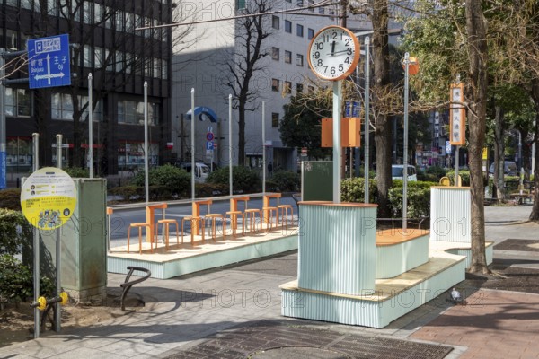 Urban design, close-up, orange Seiko clock and benches, Ikebukuro Living Loop, Public Furniture, Higashiikebukuro, Toshima City, Tokyo, Japan