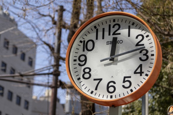 Urban design, close-up, orange Seiko clock, Ikebukuro Living Loop, Public Furniture, Higashiikebukuro, Toshima City, Tokyo, Japan