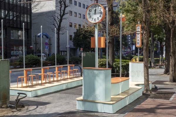 Urban design, close-up, orange Seiko clock and benches, Ikebukuro Living Loop, Public Furniture, Higashiikebukuro, Toshima City, Tokyo, Japan