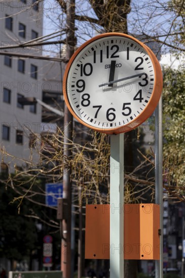 Urban design, close-up, orange Seiko clock, Ikebukuro Living Loop, Public Furniture, Higashiikebukuro, Toshima City, Tokyo, Japan